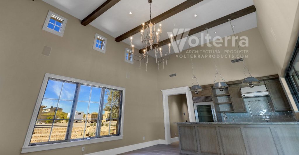 a tall living room with large and small windows