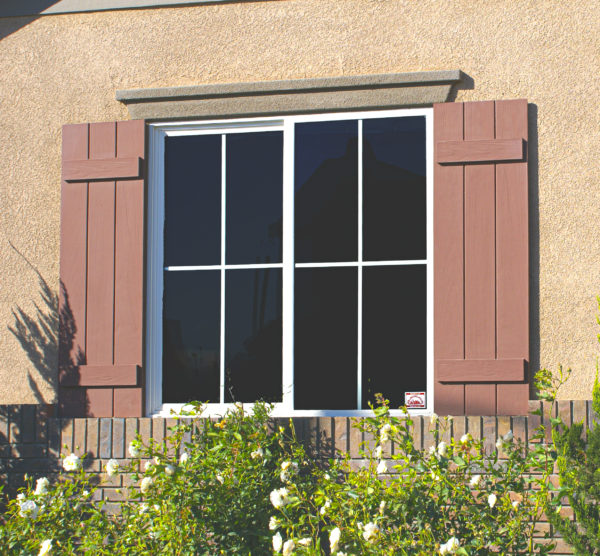 3 plank faux wood shutters on the exterior of a home