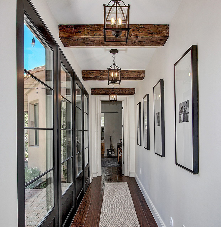 An image of Volterra’s faux wood beams installed in a hallway.