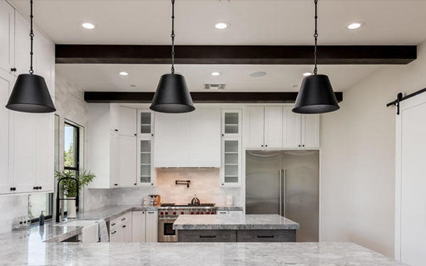 An image of dark Volterra faux wood beams in a modern farmhouse kitchen.