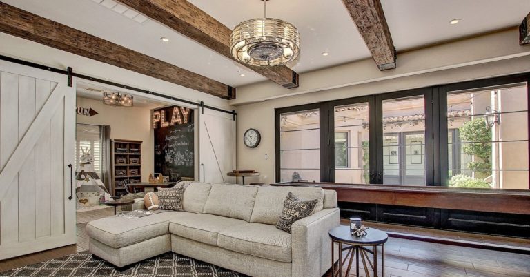 living room with faux wood beam ceiling