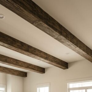 A beautifully completed, naturally lit living room with elegant, rustic faux wood beams on the ceiling, featuring a person relaxing on a sofa.