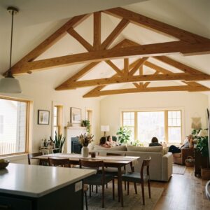 A finished, open-concept living and dining area with prominent, highly detailed decorative ceiling trusses, captured from a natural perspective.